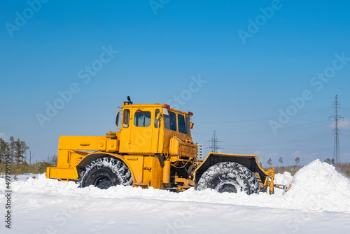 Snow removal. A large tractor clears the road after a heavy snowfall.