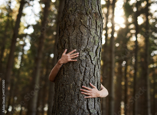 Trees deserve love too. Shot of an unidentifiable young woman hugging a tree in the forest.