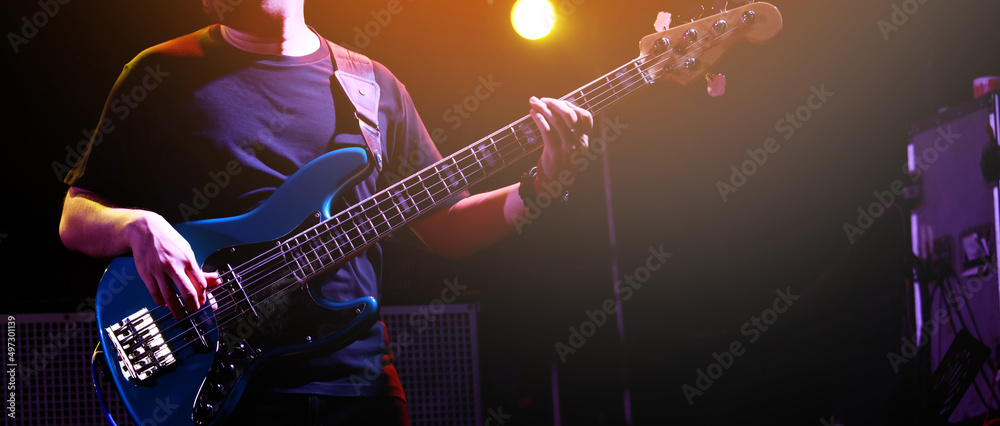 Obraz premium close up hand young man playing bass at recording studio rehearsal base. rock music band.