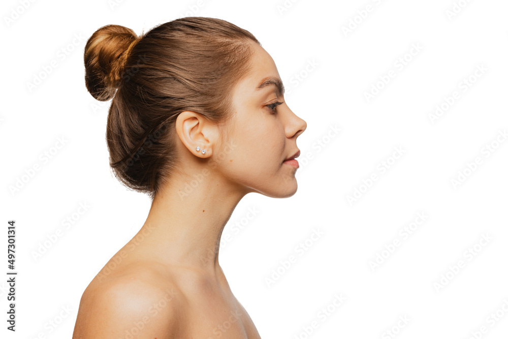 Close-up portrait of young beautiful girl with day makeup isolated over white studio background. Natural beauty concept. Close-up portrait of young beautiful girl with day makeup isolated over white studio background. Natural beauty concept.
