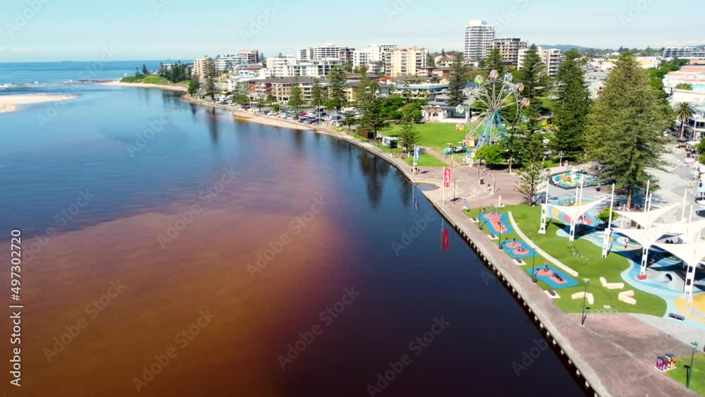Drone aerial shot of The Entrance town and foreshore lagoon channel with park merry-go-round coastline nature Central Coast tourism NSW Australia 4K Drone aerial shot of The Entrance town and foreshore lagoon channel with park merry-go-round coastline nature Central Coast tourism NSW Australia 4K