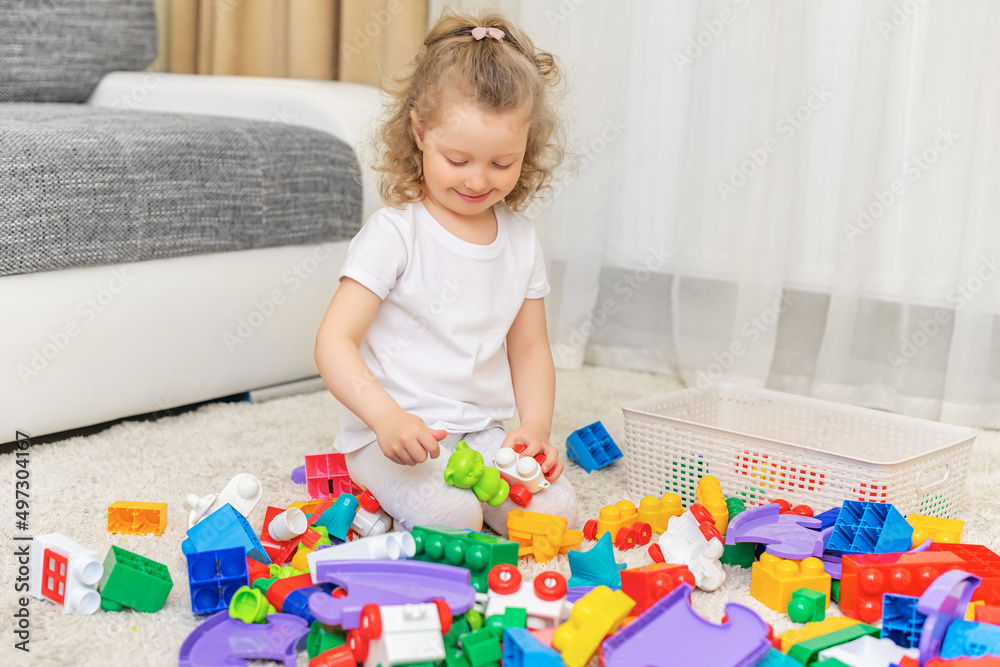The child is focused on playing with the constructor. The child is focused on playing with the constructor.