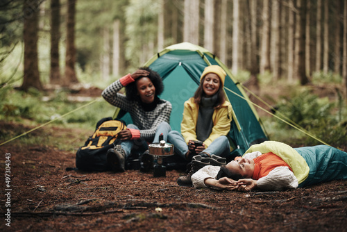 Diverse friends camping in a forest