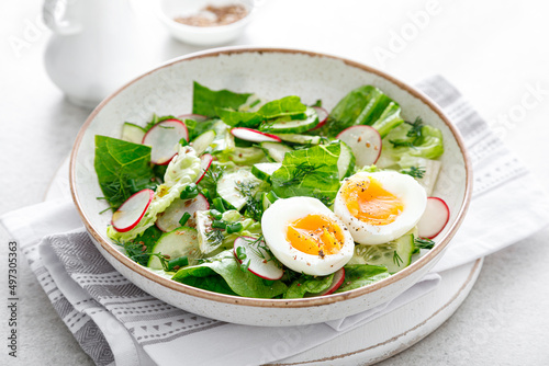Φωτογραφία Salad with radish, cucumber, romaine lettuce and soft boiled egg