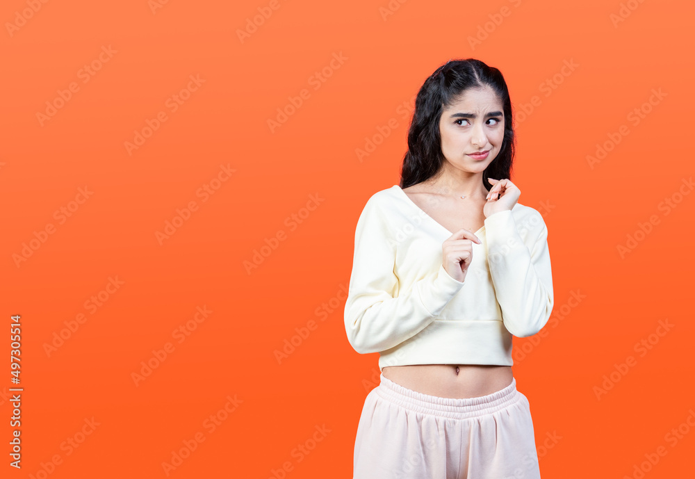 Contempt and disgust concept with young woman isolated on orange background. Contempt and disgust concept with young woman isolated on orange background.