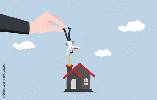 Reminder for paying off real estate or mortgage debt, bank repayment notification, Interest payment date concept. Bank staff catching tiny businessman and shaking to get money to house chimney slot. photo