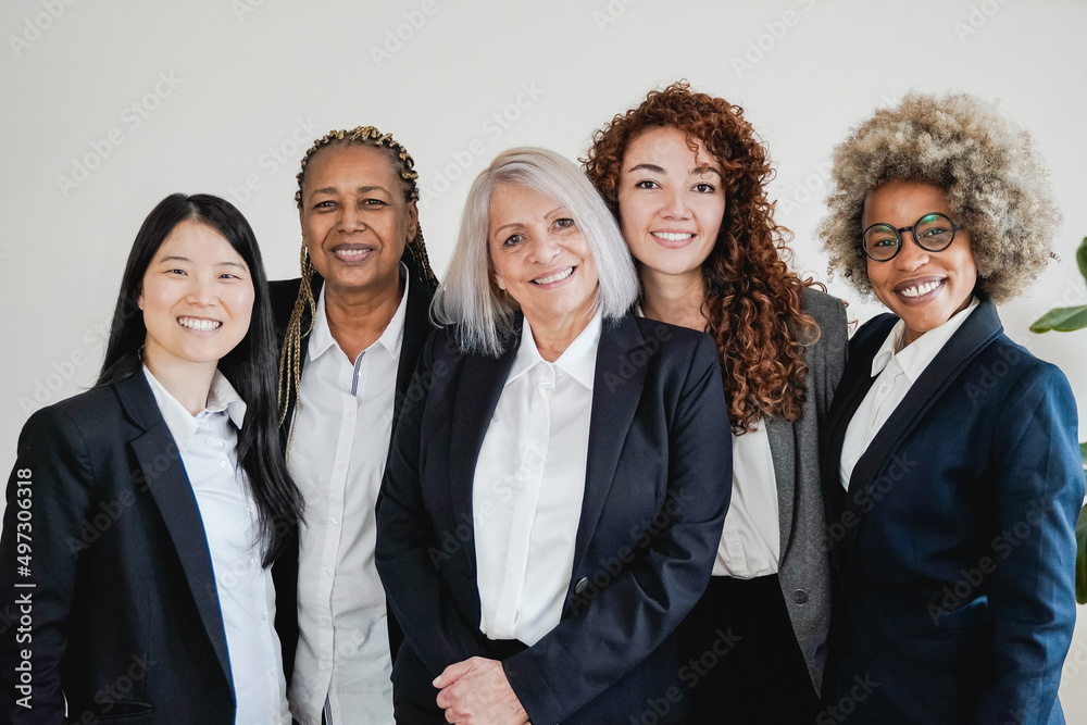 Multiracial business women smiling on camera inside bank office - Focus on African girl face Multiracial business women smiling on camera inside bank office - Focus on African girl face
