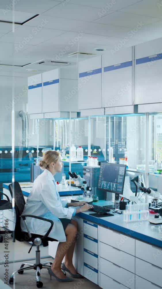 Vertical Video: Medical Science Laboratory with Diverse Team of Professional Scientists Working with Microscopes, Computers. Developing Drugs, DNA Gene Editing Technology, High-Tech Medical Research Vertical Video: Medical Science Laboratory with Diverse Team of Professional Scientists Working with Microscopes, Computers. Developing Drugs, DNA Gene Editing Technology, High-Tech Medical Research