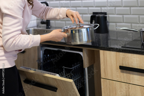 Mature woman cooks at home looking at new recipe on the internet. Learn new recipes from home thanks to online sessions of cooking schools