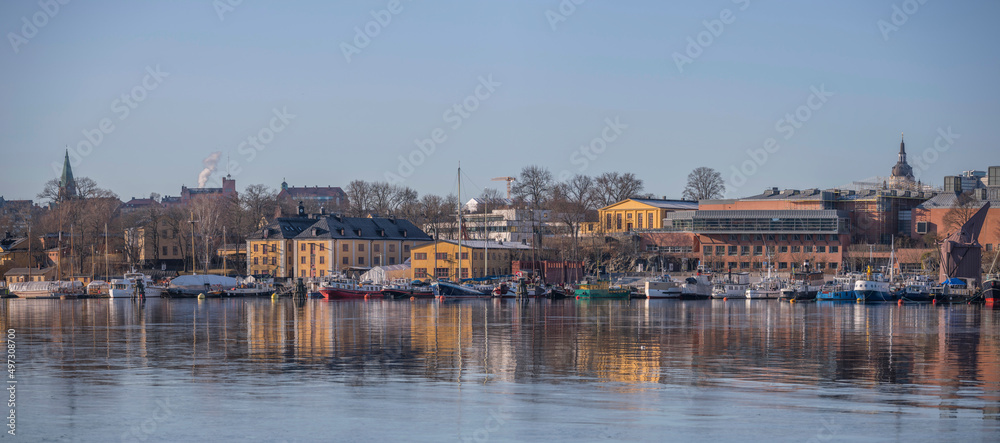 Panorama view over the island Skeppsholmen with museums and various ships at the pier, a sunny spring day in Stockholm