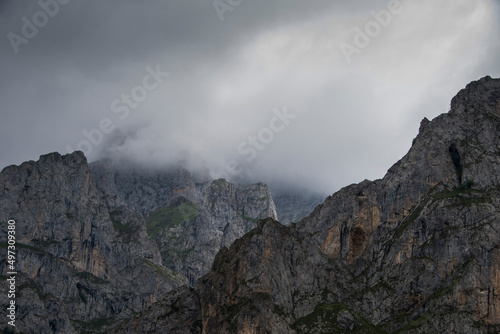 Imposing and majestic sharp limestone peaks stand tall amidst the fog