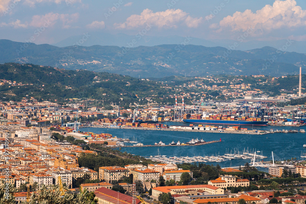 Fototapeta premium Sunny panoramic view of the city and the bay, port for ships. Tourism and transport. Rest and travel.