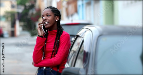 African teen girl speaking on phone. Black teenager woman talking on cellphone