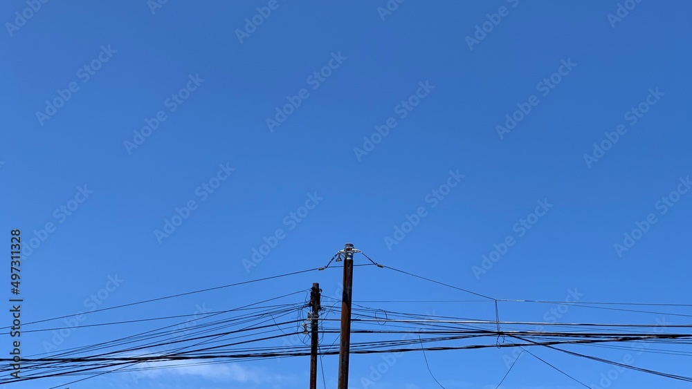 electric poles and wire cables on blue sky background