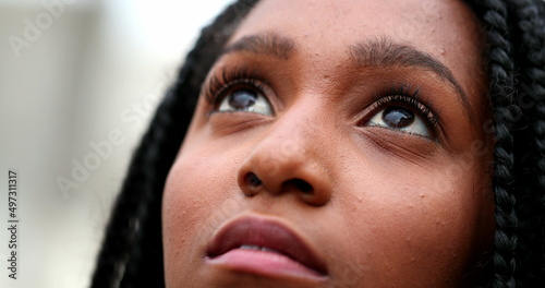 Принти на полотні African teen black girl close-up eyes looking up to sky with HOPE and FAITH