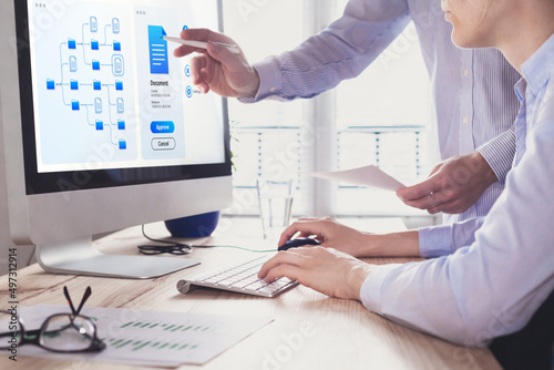 Document management system (DMS) allowing efficient business processes. colleagues working with file manager on computer screen at the office to approve a report. Digital transformation.