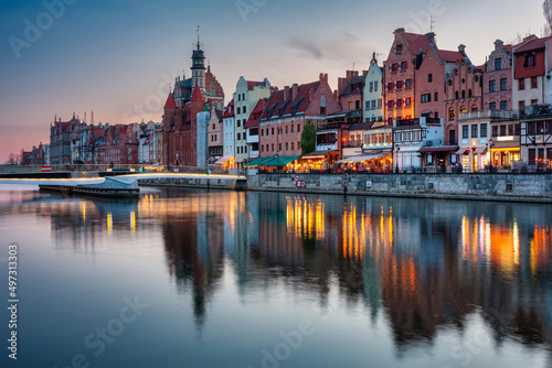 Beautiful architecture of Gdansk old town reflected in the Motlawa river at dusk, Poland