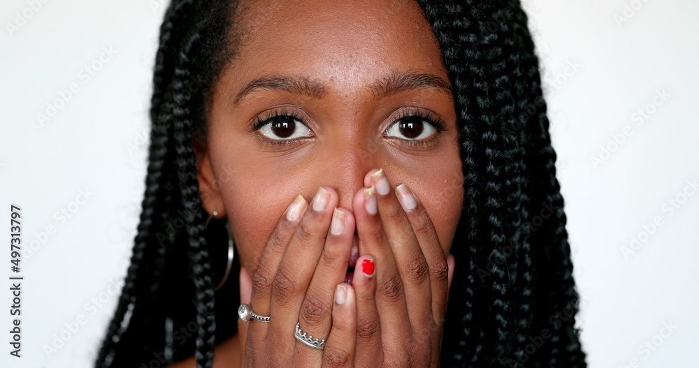 African girl surprise reaction, black teen young woman close-up face reacting with shock African girl surprise reaction, black teen young woman close-up face reacting with shock
