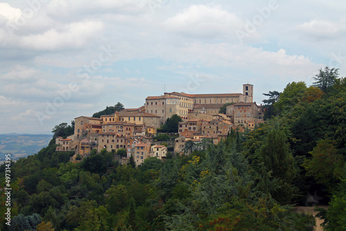 The historical city of Gubbio laying on a green hill in Umbria