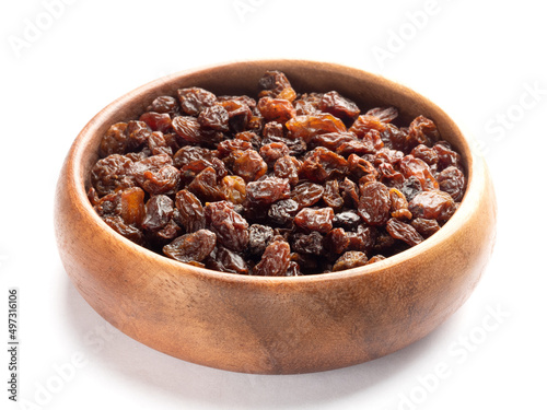 Raisin in wooden bowl isolated on white background. Macro. Healthy food concept