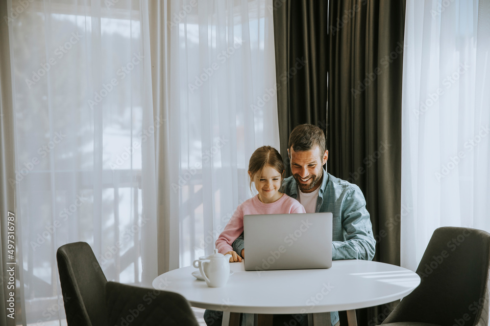 Father and daughter using laptop computer together Father and daughter using laptop computer together