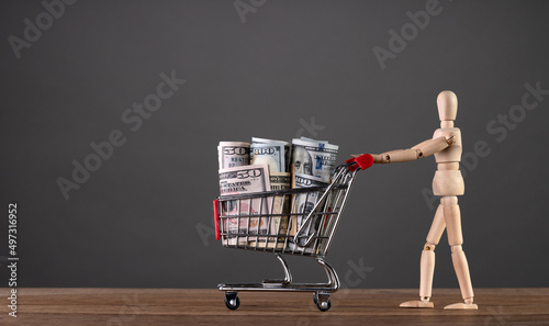 A man carries a cart from a supermarket with money