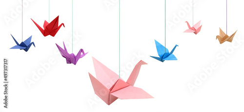 Hanging origami birds on white