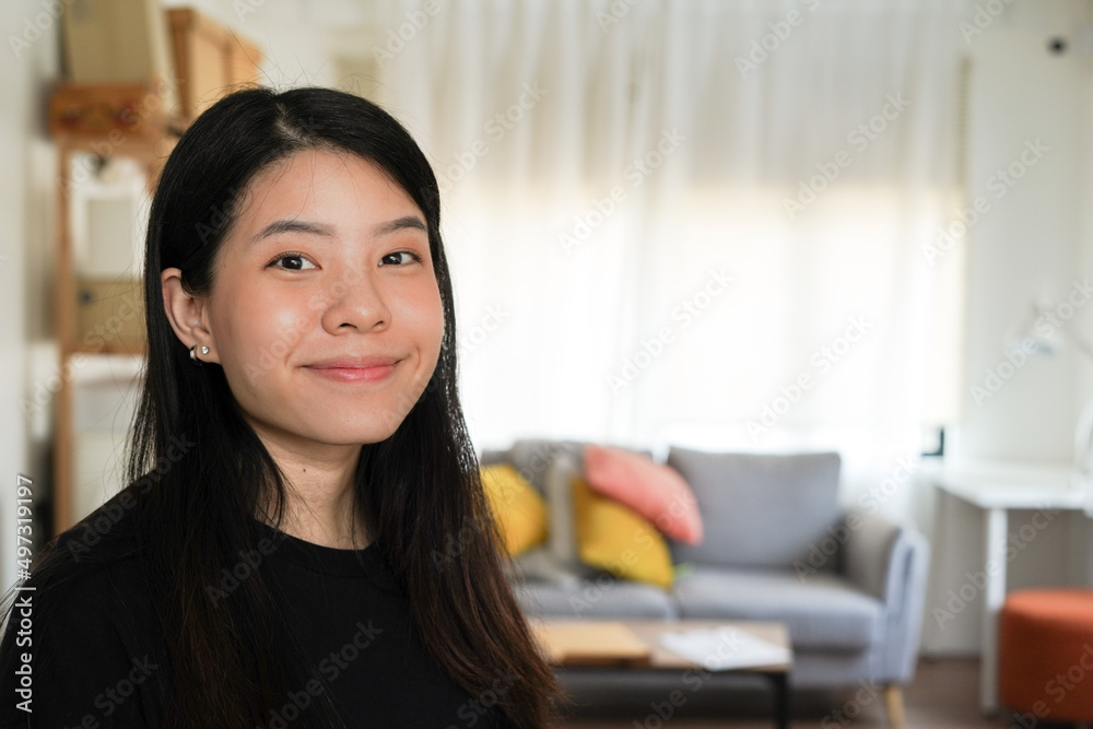 Portrait of smiling young woman stay home and social distancing from people modern lifestyle feel relax and chilled moving to the new house Portrait of smiling young woman stay home and social distancing from people modern lifestyle feel relax and chilled moving to the new house