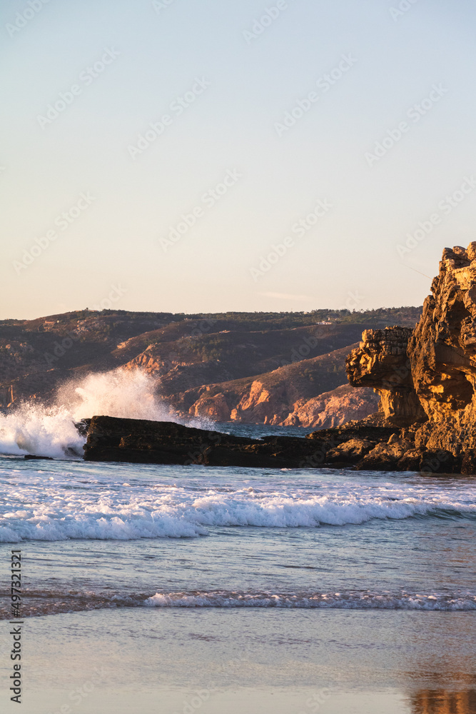 Waves crashing on the rocks during sunset