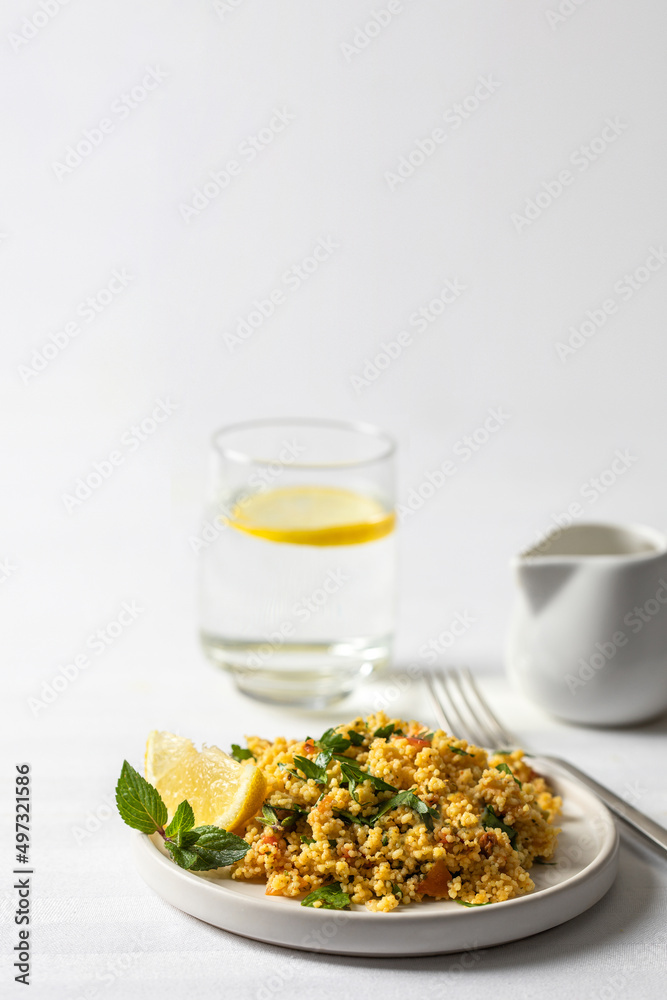 famous tabule salad with chopped parsley ,vegetables and bulgur , served with dressing mad olive oil and lemon juice on the table. famous tabule salad with chopped parsley ,vegetables and bulgur , served with dressing mad olive oil and lemon juice on the table.