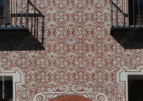Detail of facade with sgraffito geometric decoration in the historic city center of Madrid. Spain.