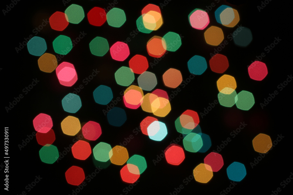 Defocused colorful lights on black background
