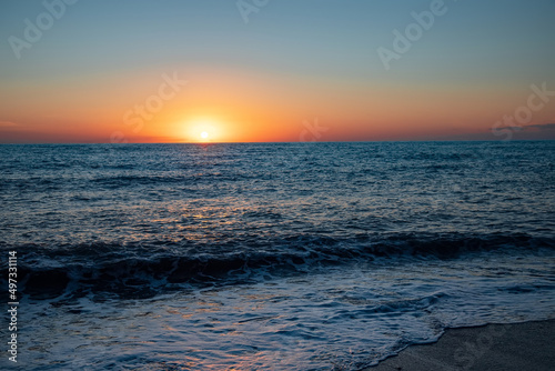 The sea wave. Sunset in the sea. The power of the elements. Landscape photography.