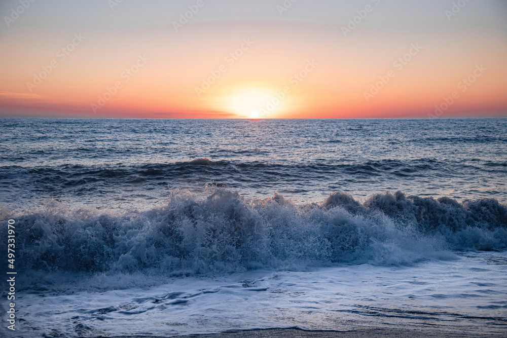The sea wave. Sunset in the sea. The power of the elements. Landscape photography.