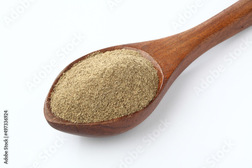Indian spices Black Pepper powder in a wooden spoon with pepper corns on white background