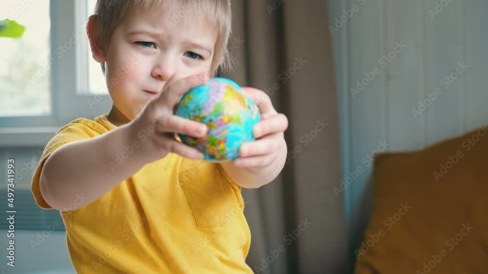 Child boy with blonde hair hugging the earth globe, save the earth concept. 3 years old kid holding a toy globe model. Baby toddler. Early, age children education development. Child boy with blonde hair hugging the earth globe, save the earth concept. 3 years old kid holding a toy globe model. Baby toddler. Early, age children education development.