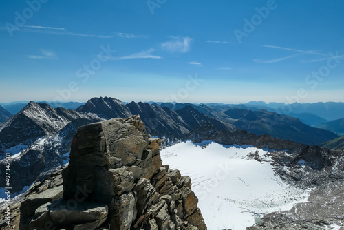 Rock formation with scenic view on Hoher Sonnblick glacier in High Tauern mountains in Carinthia, Salzburg, Austria, Europe, Alps. Goldbergkees in Hohe Tauern National Park on a sunny day. Melting ice