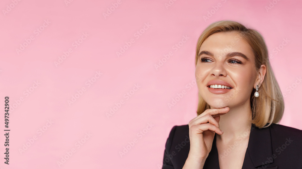 Smiling caucasian business woman with hands near face looking away on pink background, close up of girl with blond short haircut Smiling caucasian business woman with hands near face looking away on pink background, close up of girl with blond short haircut