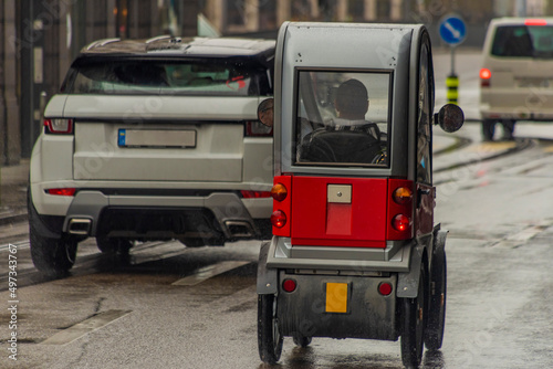 Small electric car in streets of Zurich town in rainy spring day