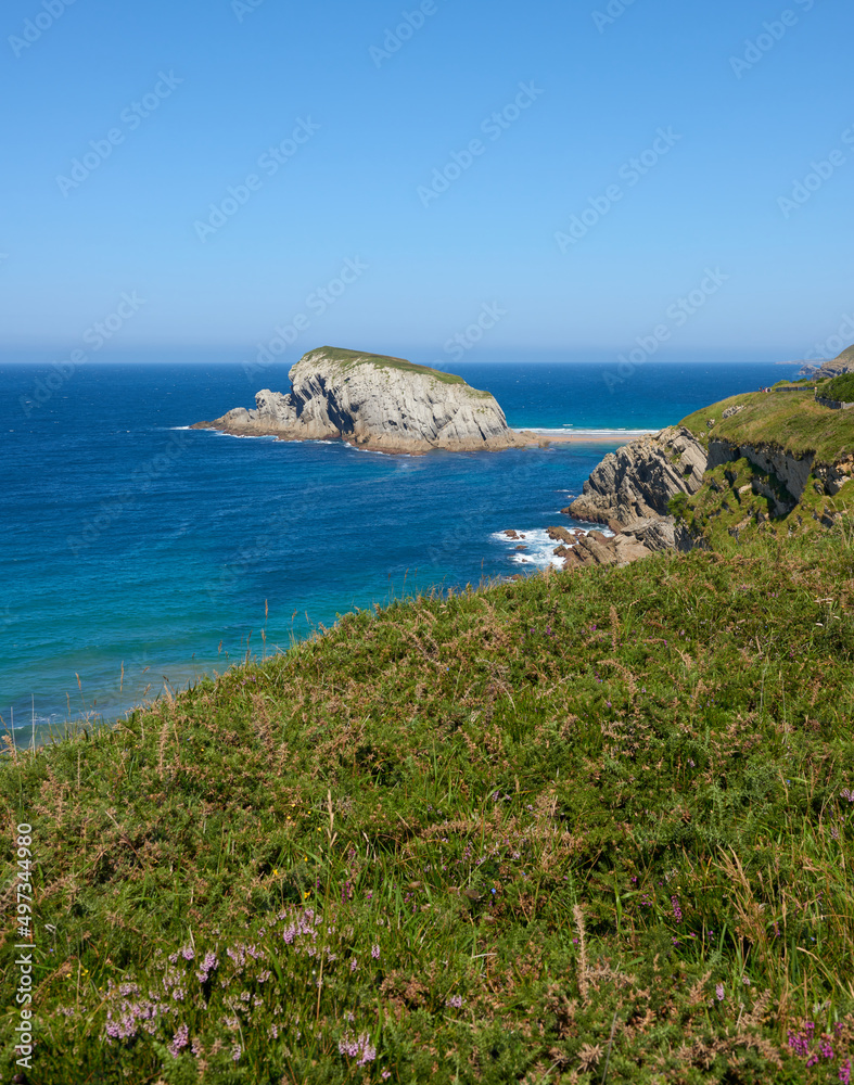 Cliffs surrounded by clear waters and blue skies