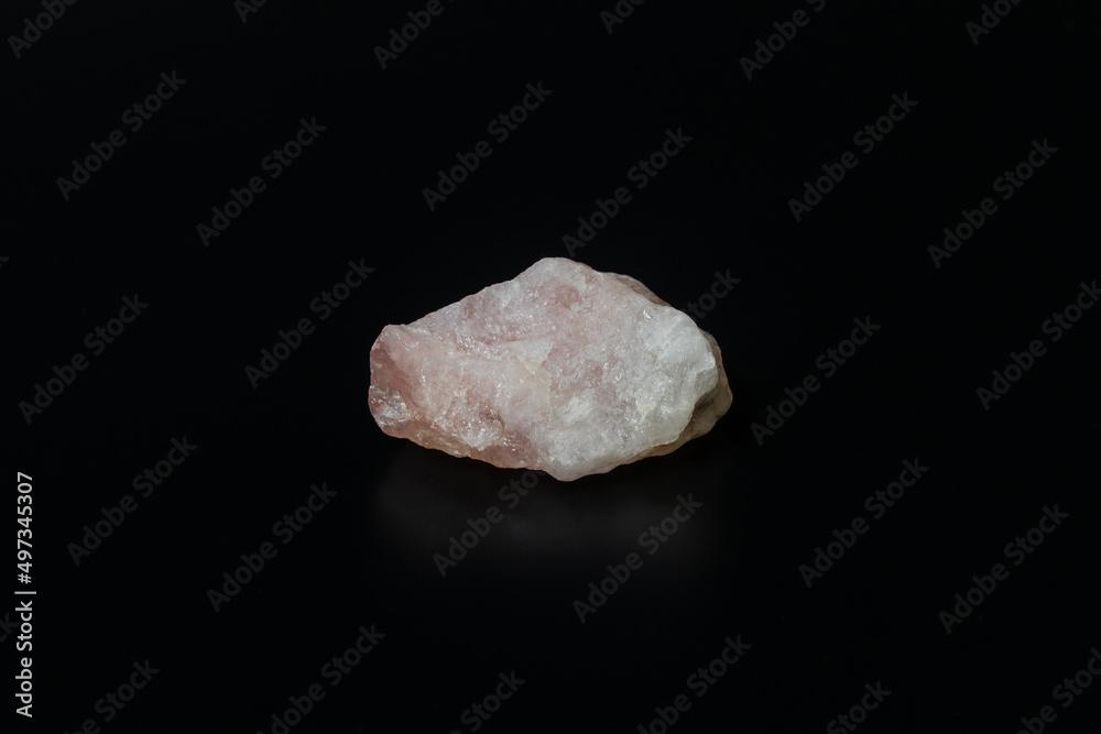 Quartz stone, Close-up of raw pink quartz stone isolated on black background. Precious raw mineral rock