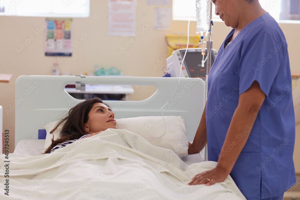I hope its good news.... Shot of a nurse talking to her patient. I hope its good news.... Shot of a nurse talking to her patient.