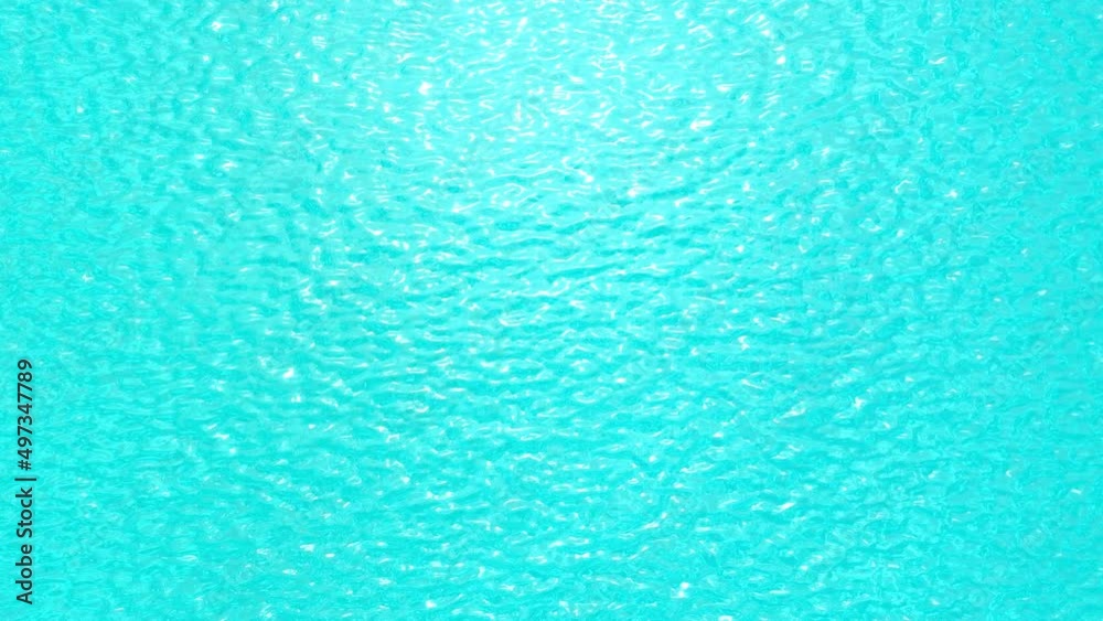 Light blue surface of water top view 3D sunny summer background. Ripple on the sea and glares of the sun aerial shot 4K. Paradise view with copy space Light blue surface of water top view 3D sunny summer background. Ripple on the sea and glares of the sun aerial shot 4K. Paradise view with copy space