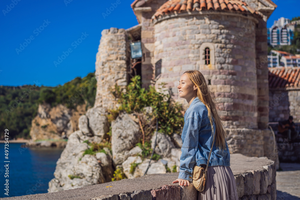 Young woman tourist in the old town of Budva. Travel to Montenegro concept
