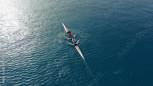 Aerial drone top down photo of woman practice competition sport canoe in deep blue sea