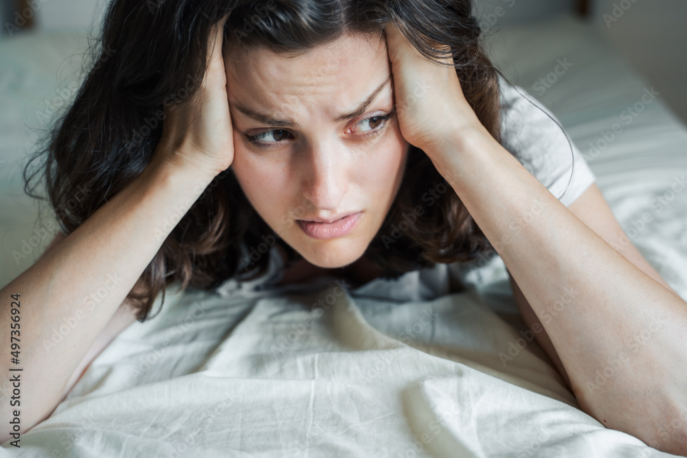 Sad, unhappy woman lying on bed in depression. Headache,stress,anxiety,tension,psychological problems. Poor mental health,visiting psychologist,psychotherapy session.Worries about work,family divorce Sad, unhappy woman lying on bed in depression. Headache,stress,anxiety,tension,psychological problems. Poor mental health,visiting psychologist,psychotherapy session.Worries about work,family divorce