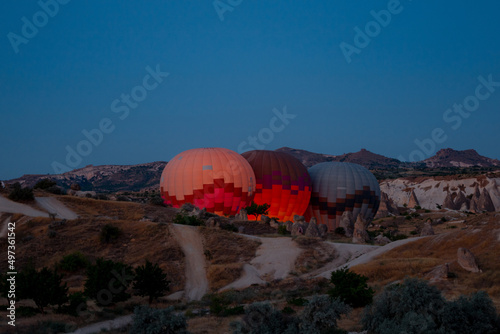 Hot air balloons are ready to take off in Cappadocia at sunrise