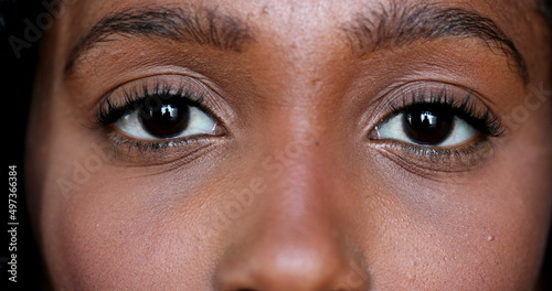 Close-up African young woman eyes looking at camera, Macro closeup black girl eye