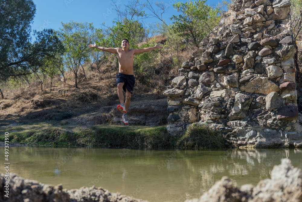a man jumping into the water in a river