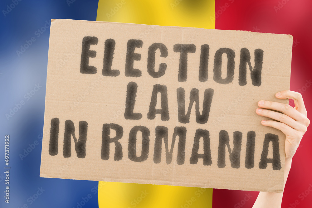 The phrase " Election law in Romania " on a banner in men